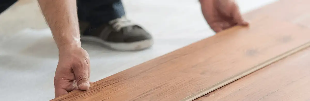 A professional installing laminate flooring in Pasadena, CA